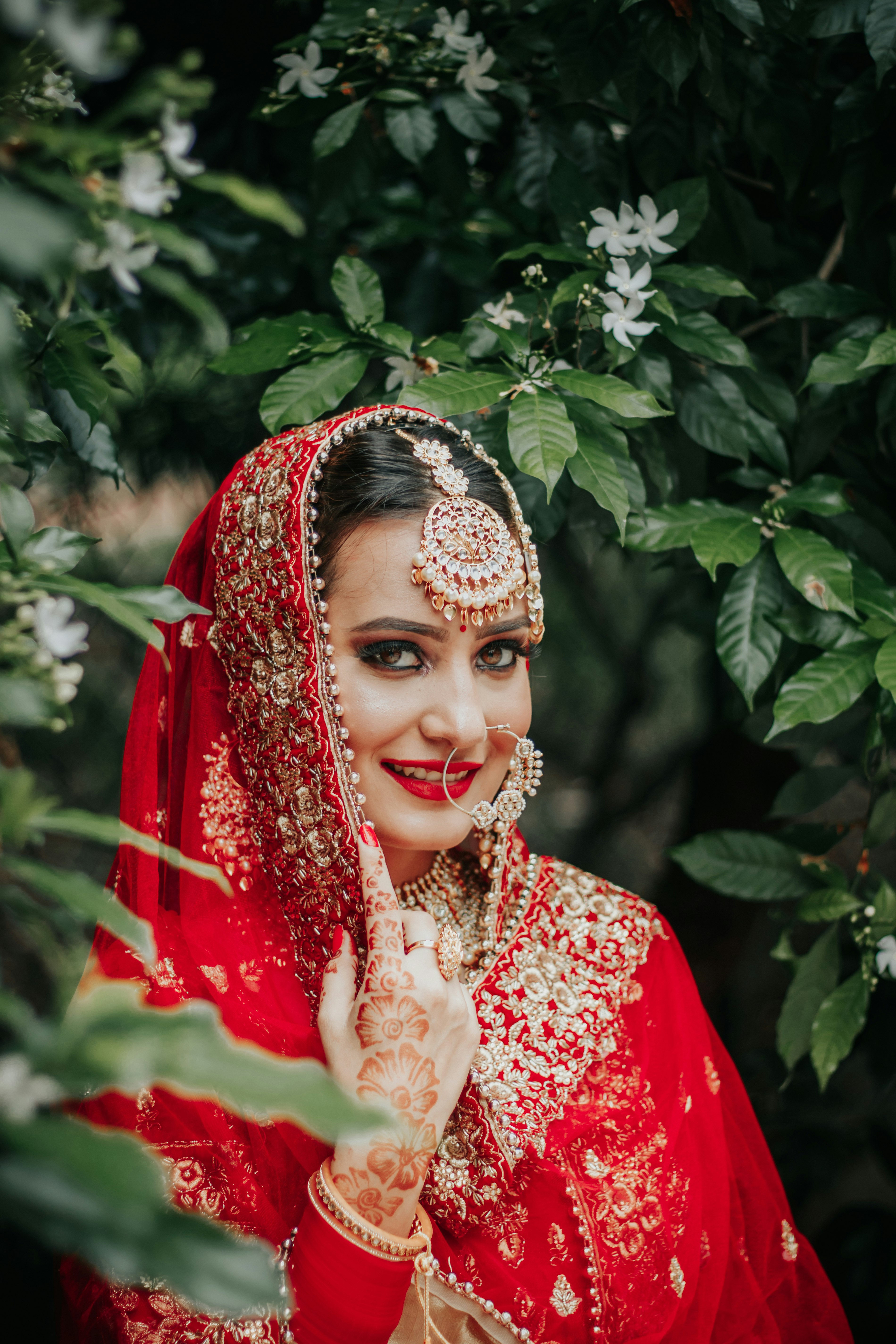 woman in red and white floral dress wearing white and black floral headdress